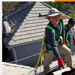 Dove Canyon Roof Repair 7 Two roofers wearing safety harnesses while working on a tile roof